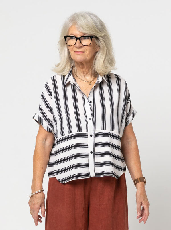 Lady wearing a black and white striped shirt made with the Blaire Shirt Sewing Pattern – Square-shaped with rolled cuffs and overlay.