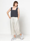 Image of the Byron Woven Top sewing pattern, highlighting the square neck, sleeveless design, and deep hem facing with topstitching, suitable for various elegant fabrics.