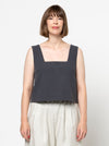 Image of the Byron Woven Top sewing pattern, highlighting the square neck, sleeveless design, and deep hem facing with topstitching, suitable for various elegant fabrics.