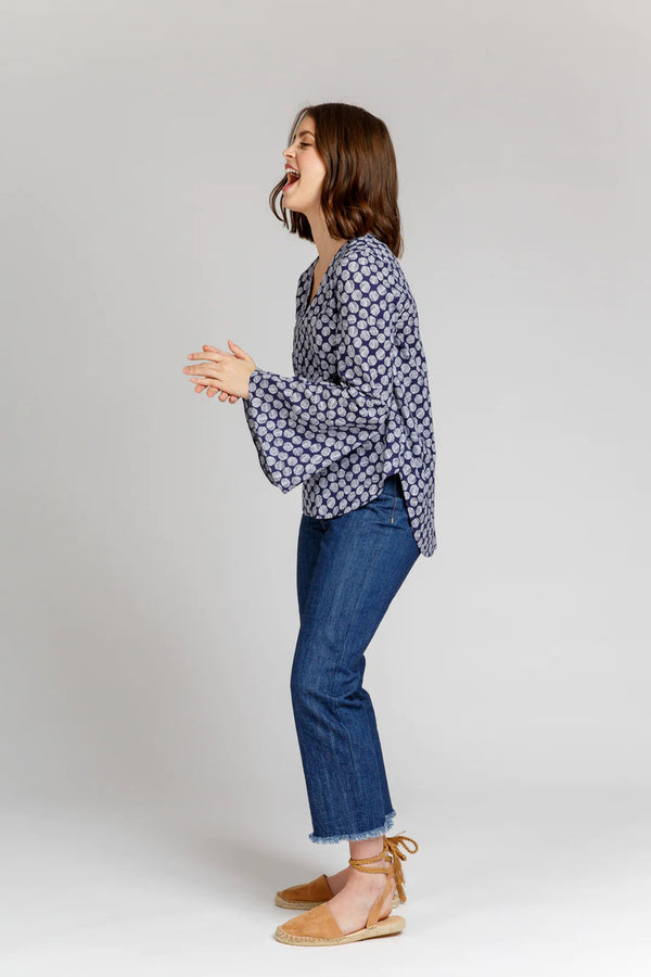 Dove blouse sewing pattern by Megan Nielsen with statement sleeve cuffs, french darts, v neckline, and curved hemline, available in three sleeve variations.
