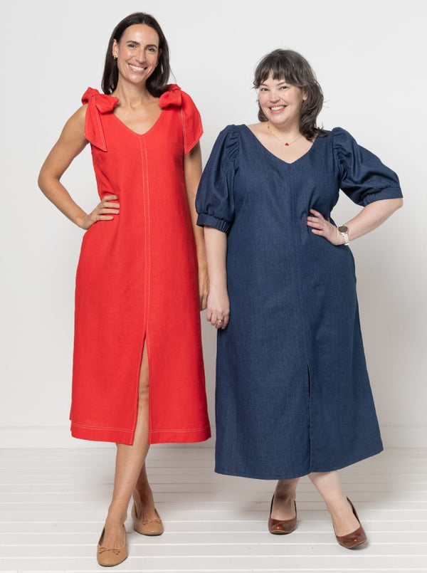 Two women wearing red and blue dresses made using a style arc Esther woven dress sewing pattern posing against a white background