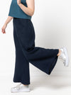 Loddon Woven Pant sewing pattern, featuring wide-leg, full-length pants with elastic waist, flat front waistband, and angled pockets, suitable for washed linen, crepe, viscose, or fine wool fabrics.
