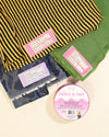 Fabric with different patterns and a roll of fabric tape on a beige background