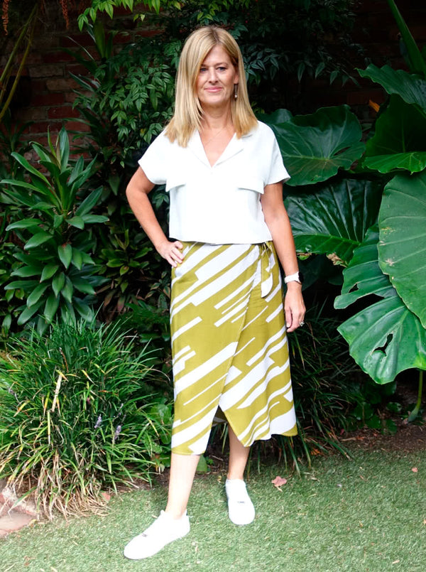 Stylish Rona Wrap Skirt sewing pattern with full faux wrap, calf-length cut, and front tie waist, suitable for rayon, crepe, silk, or washed linen fabrics.