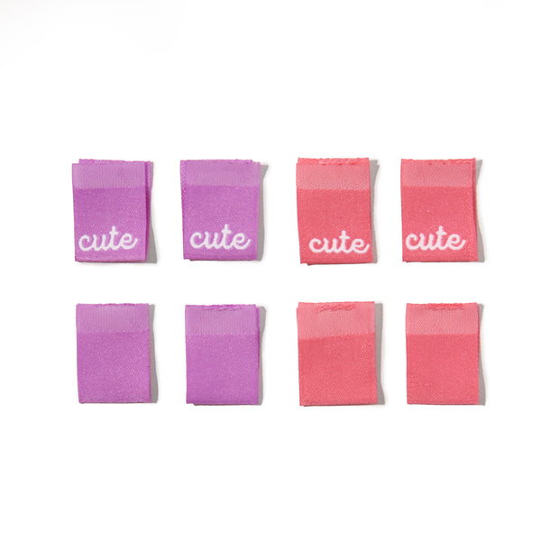 Set of pink and purple scrunchies with 'cute' text on a white background