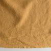 Close-up of Autumn Mustard extra wide 280cm 100% linen fabric 300gsm for jackets, aprons, cushions, curtains and structured home textilest gray background