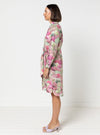 Woman wearing a floral dress made using Avon Woven Shirt and Dress sewing patternon a white background