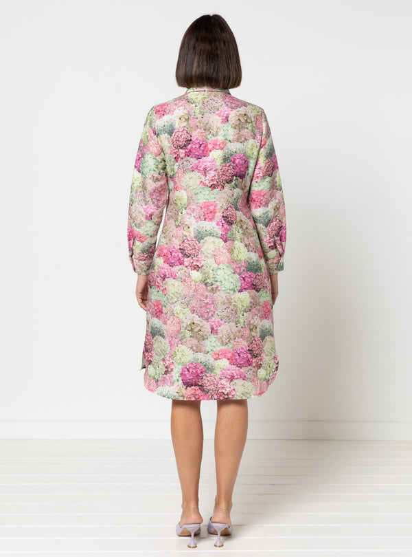 Woman wearing a floral dress made using Avon Woven Shirt and Dress sewing pattern against a white background