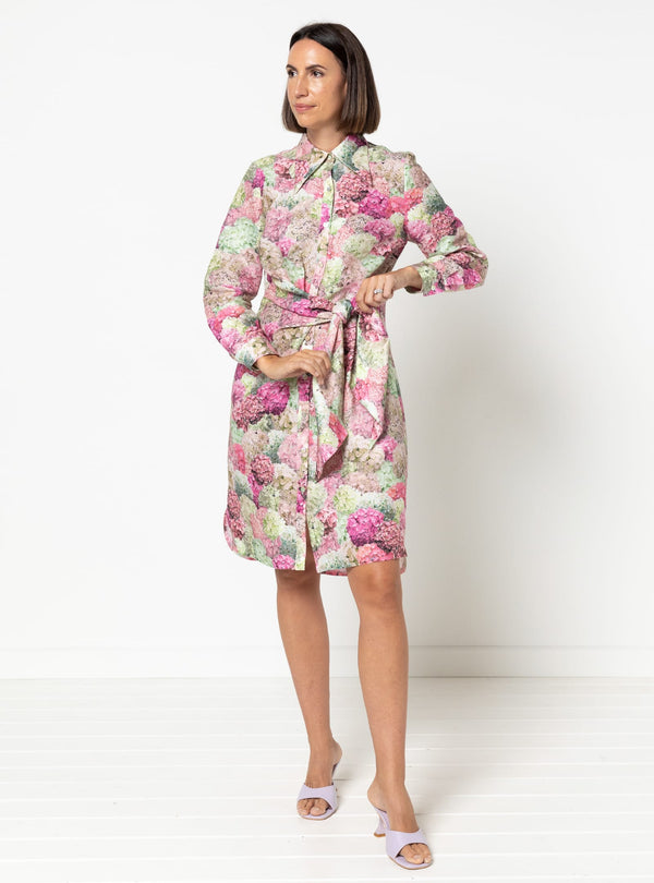 Woman wearing a floral dress rmade using Avon Woven Shirt and Dress sewing pattern against a white background