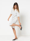 Woman wearing a white polka dot dress made using Avon Woven Shirt and Dress sewing pattern on a white background