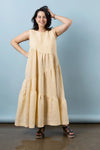 Woman wearing a beige sleeveless dress made using Azure Dress, Skirt, and Top sewing patternmade using Azure Dress, Skirt, and Top sewing patternagainst a plain background