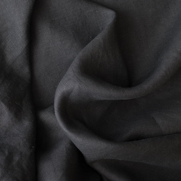 Close-up of black linen fabric with folds