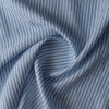 Close-up of Bluehaven Pinstripe linen fabric in pale blue with fine navy pinstripes, 100% linen, 140 GSM, 60 LEA yarn dyed