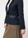 Navy blazer made using the Bronnie Tuxedo Jacket Sewing patternworn by a person on a plain background
