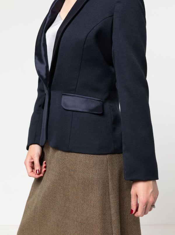 Navy blazer made using the Bronnie Tuxedo Jacket Sewing patternworn by a person on a plain background