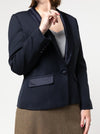 Navy blazermade using the Bronnie Tuxedo Jacket Sewing patternworn by a person on a white background