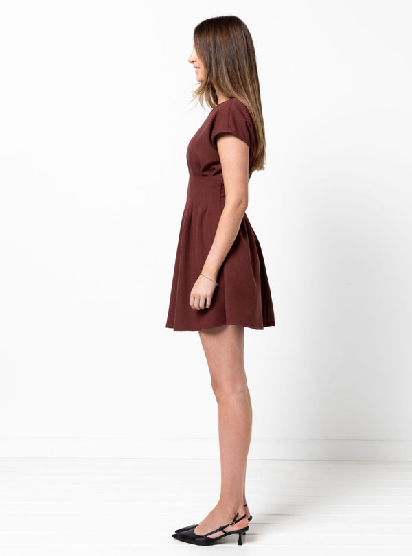 Woman wearing a brown dress made using Bronte Woven Dress sewing pattern on a white background