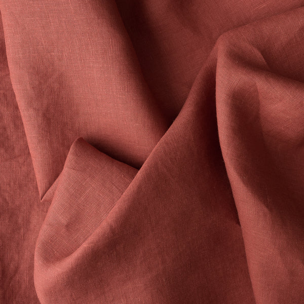Close-up of rust-colored fabric with folds