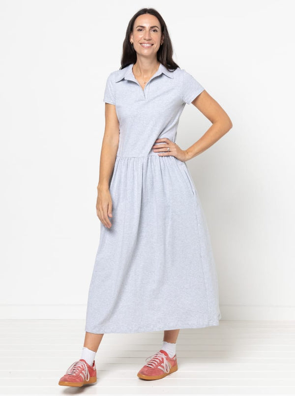Woman wearing a light blue Carter Dress made using StyleArc pattern with tee bodice and mid-calf linen skirt with a white background