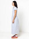 Woman wearing a light blue Carter Dress made using StyleArc pattern with tee bodice and mid-calf linen skirt on a white background