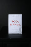 White packet with 'Tool & Anvil' text on a black background