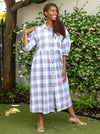 front view of Emerald Woven Shirt Dress sewing pattern featuring a waisted fit, irregular tucked skirt, shirt collar, optional sleeves or sleeveless style, and inseam pockets