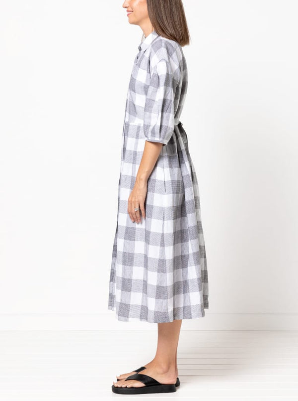 side view of Emerald Woven Shirt Dress sewing pattern featuring a waisted fit, irregular tucked skirt, shirt collar, optional sleeves or sleeveless style, and inseam pockets