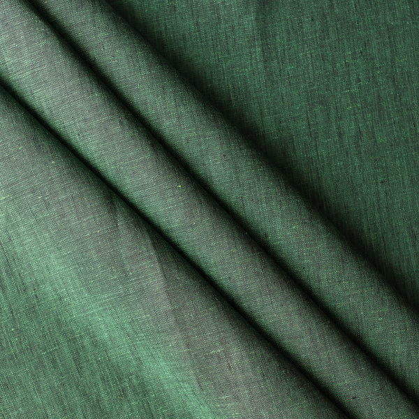Close-up of Forest Chambray linen fabric in deep earthy green with green-and-black chambray weave, 100% linen, 160 GSM
