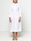Person wearing a white dress against a plain background. The dress is made from the Hampton Woven Dress Sewing Pattern – a mid-calf shirtdress with a gathered skirt, curved waist, sleeve or sleeveless options, and inseam pockets.