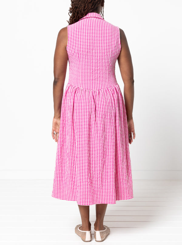 Person wearing a pink checkered dressmade from the Hampton Woven Dress Sewing Pattern on a white background