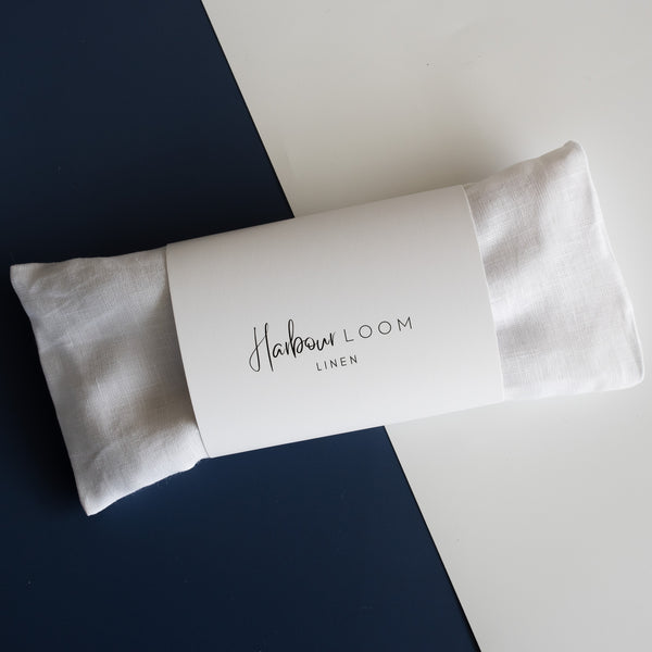 Handmade White Linen Eye Pillow made in Australia, filled with Organic Australian Golden Linseed and optional Organic Lavender Flowers. Includes a removable and washable 100% linen cover, ideal for yoga, meditation, and stress relief. Size: 22cm x 10cm, weight: 210-220g.
