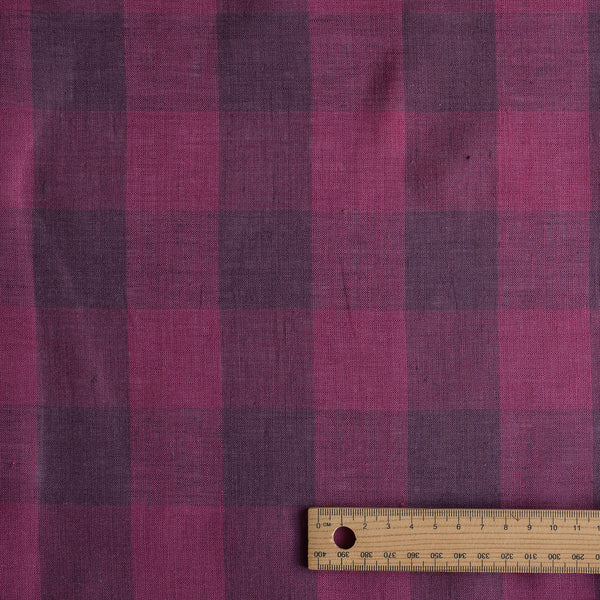 Purple checkered fabric with a wooden ruler for scale