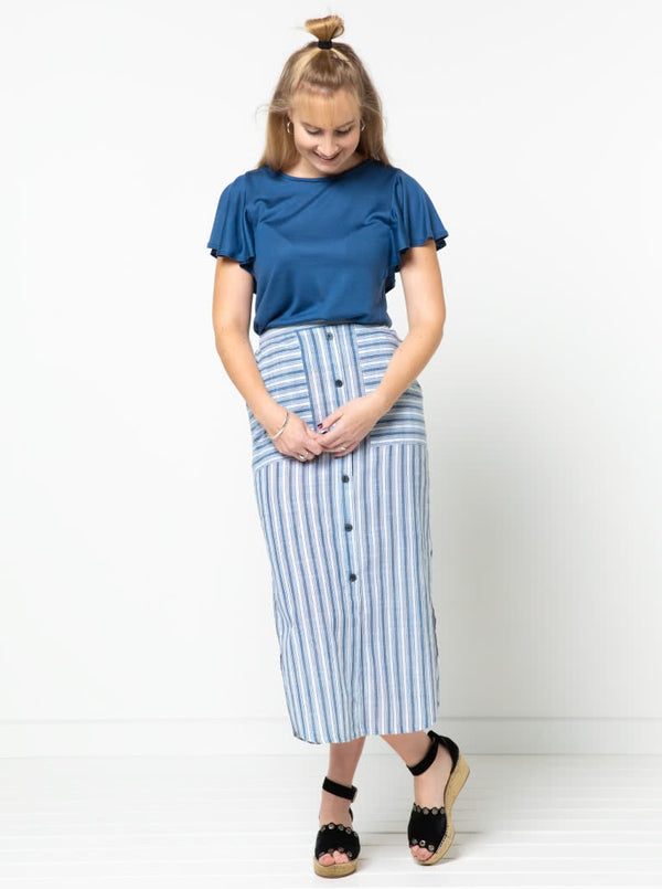 Indigo Maxi Skirt sewing pattern, featuring an elastic waist, faux button opening, patch pockets, and side splits, ideal for cotton, linen, crepe, or rayon fabrics.