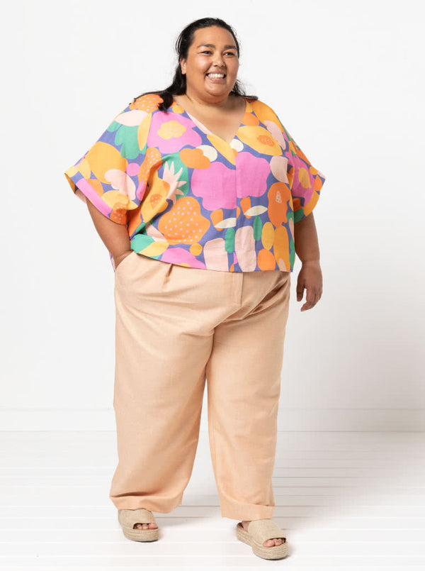 Joan Woven Top sewing pattern featuring a square shape, V-neck, extended shoulder line with band, and wide hem facings, suitable for washed linen, charmeuse, crepe, and rayon fabrics.