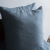 Lake Blue 100% Linen European Pillowcase on a bed with a neutral background