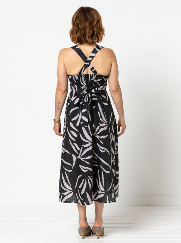 Livvy Woven Dress sewing pattern, featuring a crossover bodice sundress with fitted waist, shirred back, full skirt, and mid-calf length, suitable for cotton, rayon, silk, or lightweight linen fabrics.