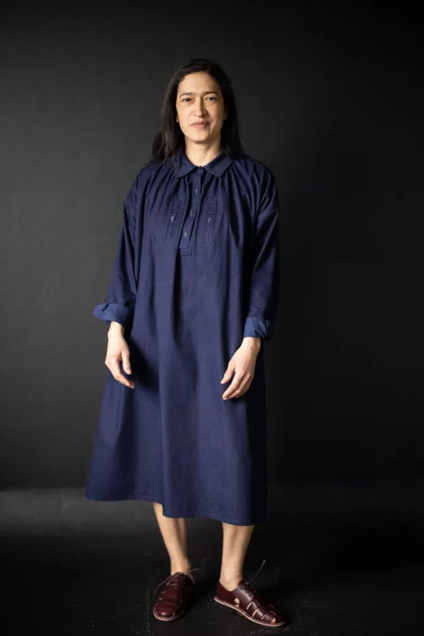Person wearing a blue The Cawley Sewing Pattern by Merchant & Mills against a black background