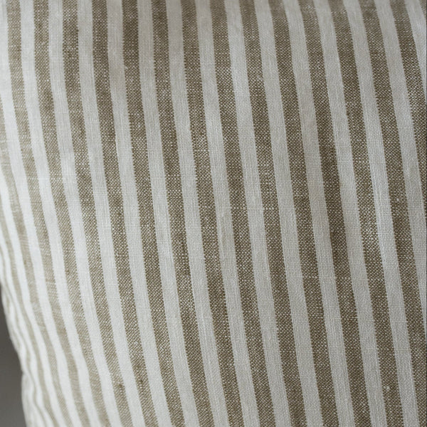 Olive Striped pillow with brown and white lines on a neutral background