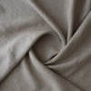 A close-up of drapedRaw Trace Extra Wide Heavy Linen Fabric Australia with a soft, textured weave, arranged in elegant folds.