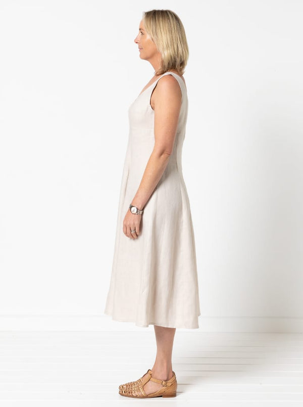 A sophisticated sleeveless dress with a high-waisted fitted bodice, gored skirt, and invisible zip, made from luxurious linen fabric.