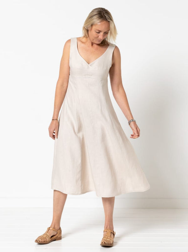 A sophisticated sleeveless dress with a high-waisted fitted bodice, gored skirt, and invisible zip, made from luxurious linen fabric.
