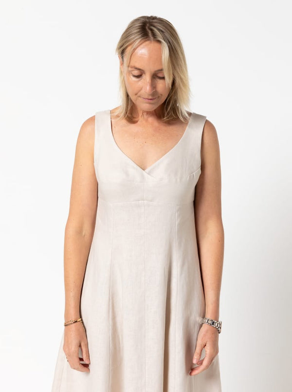 A sophisticated sleeveless dress with a high-waisted fitted bodice, gored skirt, and invisible zip, made from luxurious linen fabric.