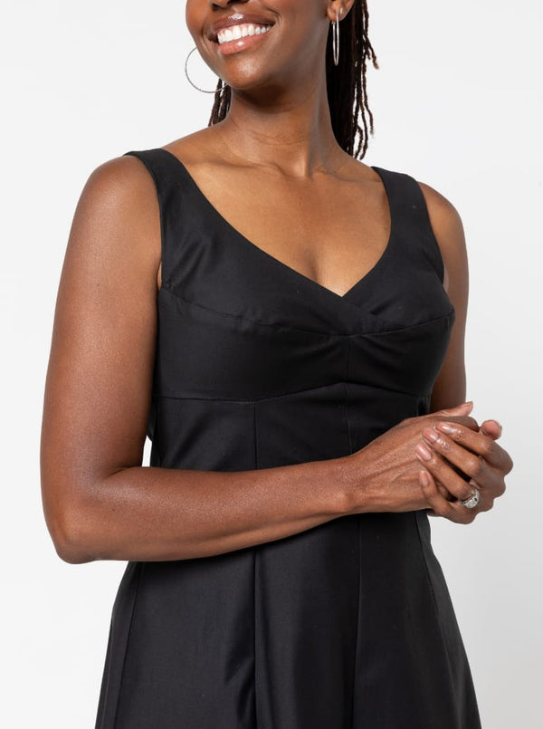 A sophisticated sleeveless dress with a high-waisted fitted bodice, gored skirt, and invisible zip, made from luxurious linen fabric.