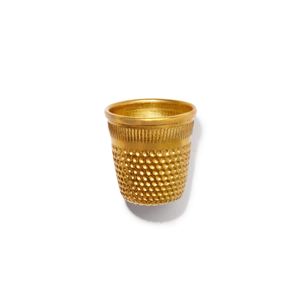 Gold textured cup on a white background