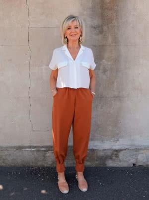 Elegant Barbara Jumpsuit with shoulder ruffle and pleated cuffs, alongside versatile pleated cuff pants pattern.