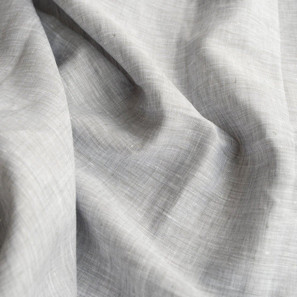 Sophisticated Chrome Grey Linen Fabric with a fine linen texture and a blend of white warp and grey weft, ideal for creating elegant and timeless clothing.