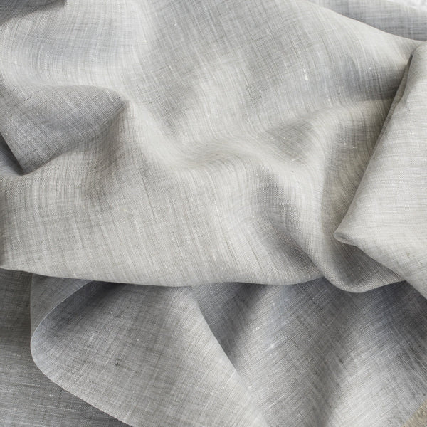 Sophisticated Chrome Grey Linen Fabric with a fine linen texture and a blend of white warp and grey weft, ideal for creating elegant and timeless clothing.