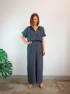 Stylish Eadie Woven Jumpsuit/Dress and Norman Jumpsuit pattern with extended shoulder line, wide legs, and front split skirt, offering a contemporary look.