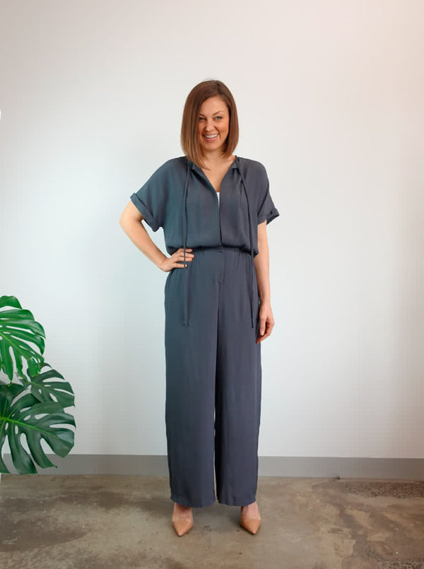Stylish Eadie Woven Jumpsuit/Dress and Norman Jumpsuit pattern with extended shoulder line, wide legs, and front split skirt, offering a contemporary look.