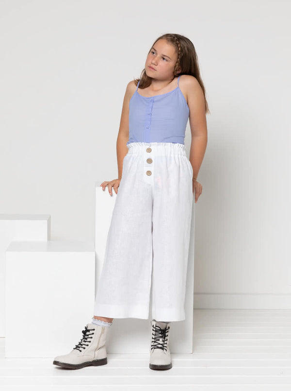 Chic Penny Teens swing dress or top sewing pattern featuring a shirred back panel, rouleau straps, and a faux button opening, designed for cotton, linen, and rayon fabrics